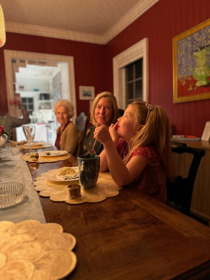 Three generations of the family gathered around the dining table